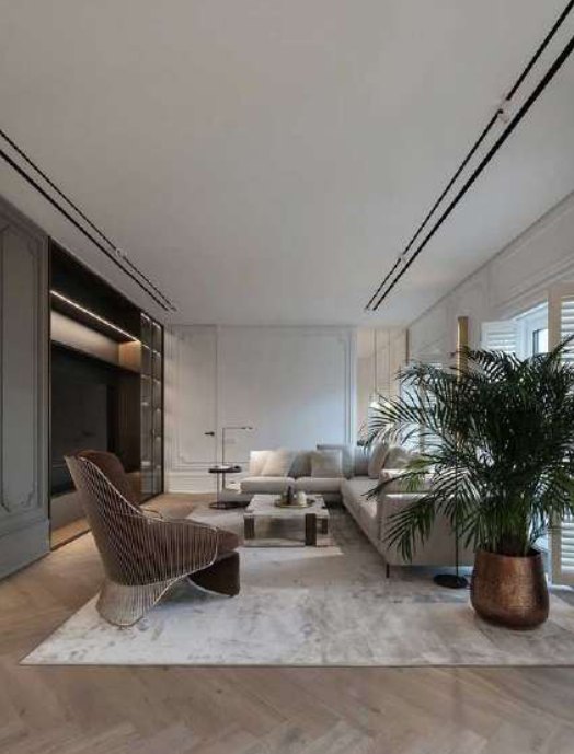 Salón moderno con carriles de luz en el techo y butaca de diseño